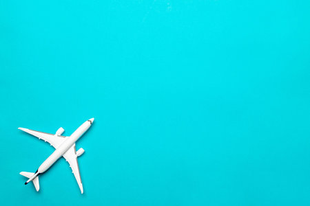 Kids playing toys. White airplane, aircraft in top view on bright blue backdrop. Flight air plane...
