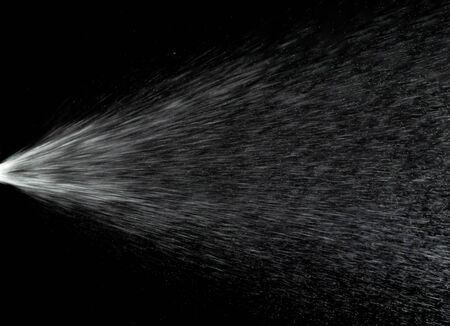 Water mist splash bottle isolated on black background. Spray liquid aerosol for perfume.の写真素材