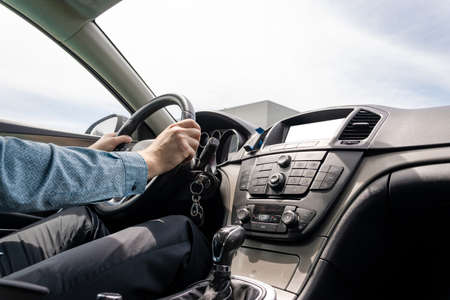 Driver car. Fun drive in summer vacation ride day. Happy young man have road travel trip inside car in sunny day.の写真素材