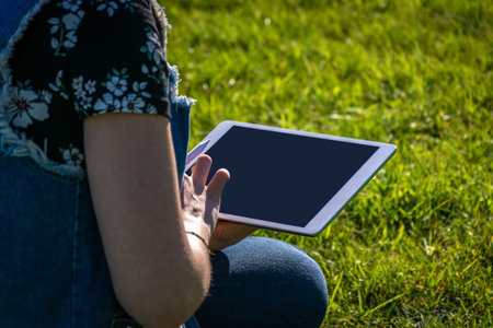 Student girl person work on tablet, computer in summer park. Online woman in nature outside. Laptop...