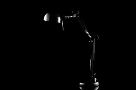 Table light furniture decor. Modern home lamp on office desk isolated on black background.の写真素材