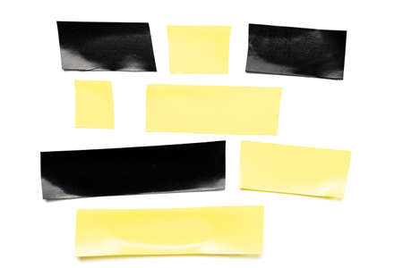Tape roll. Adhesive paper or yellow and black sticky piece scotch isolated on white background. Torn strip grunge textureの写真素材