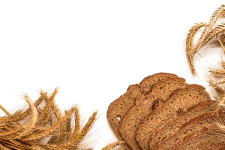 Delicious bread. Fresh loaf of rustic traditional bread with wheat grain ear or spike plant isolated...