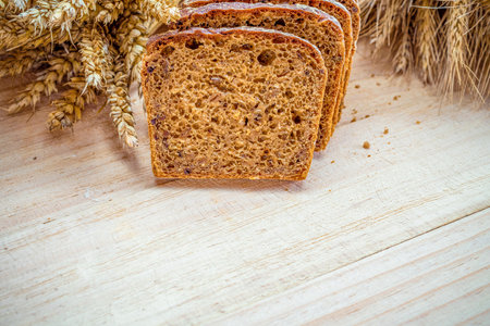 Traditional bread. Fresh loaf of rustic traditional bread with wheat grain ear or spike plant on...