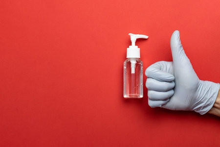 Medical background red. Medical antibacterial sanitizer gel and lab gloves on Virus protection...