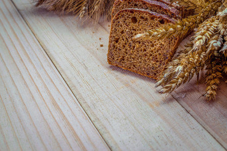 Traditional bread. Fresh loaf of rustic traditional bread with wheat grain ear or spike plant on...