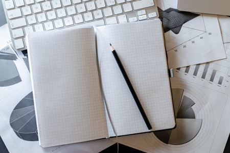 Reviewing documents charts graphs and analysis documents on workspace. Financial analytics...