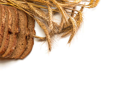 Freshly baked bread. Fresh loaf of rustic traditional bread with wheat grain ear or spike plant isolated on white background. Rye bakery with crusty loaves and crumbs. Healthy food conceptの写真素材