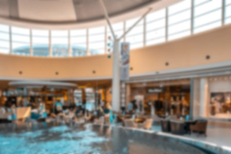 Young people shopping mall blurred background. Interior of retail center store in soft focus. People...