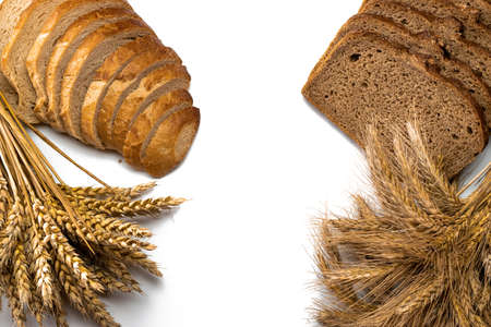 Loaf bread. Rye bakery with crusty loaves and crumbs. Fresh loaf of rustic traditional bread with wheat grain ear or spike plant isolated on white background. Bio ingredients, very healthy seedsの写真素材