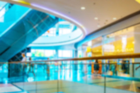 Escalator people blurred background. Interior of retail center store in soft focus. People shopping...