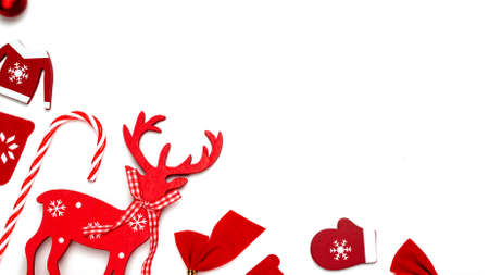 Holiday winter background. Stocking, gifts, winter tree, ribbon and bow in shape frame on white background for greeting card. Flat lay, top view, copy spaceの写真素材