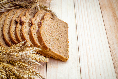 Sliced Multigrain. Rye bakery with crusty loaves and crumbs. Fresh loaf of rustic traditional bread...