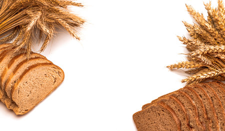 Delicious bread. Fresh loaf of rustic traditional bread with wheat grain ear or spike plant isolated...