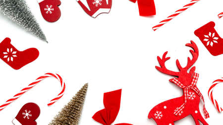 Christmas composition. Stocking, gifts, winter tree, ribbon and bow in shape frame on white background for greeting card. Flat lay, top view, copy spaceの写真素材