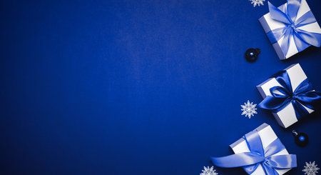 Gift boxes cyan. White gifts with cyan ribbon, New Year balls and winter tree in Christmas...