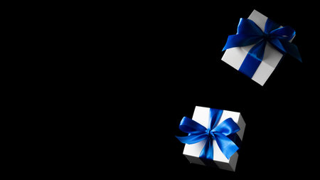 Online shopping gifts. White gifts with blue bow falling on black background for Black Friday...