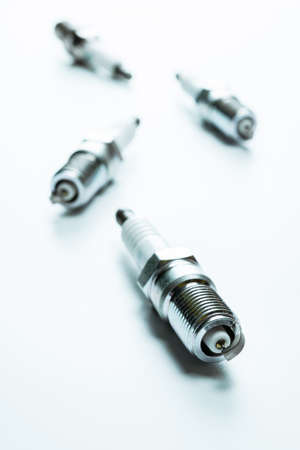 Car engine. Set of new metal car part. Auto spark plugs or automotive piece isolated on white background. Automobile engine serviceの写真素材
