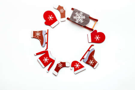 Winter design. Stocking, gifts, winter tree, ribbon and bow in shape frame on white background for greeting card. Decoration and copy space for your textの写真素材