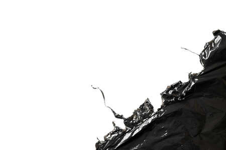 Plastic bag texture. Wrap transparent dark cellophane isolated on white background with copy space. Black shiny film pattern for packaging, product protectionの写真素材