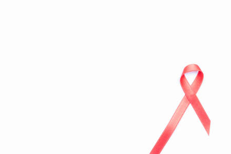 Hiv day. Red ribbon symbol in hiv world day isolated on white background. Awareness aids and cancer. Aging health month conceptの写真素材
