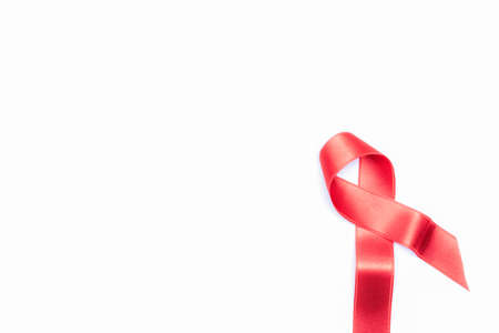 Breast cancer woman. Red ribbon symbol in hiv world day isolated on white background. Awareness aids and cancer. Healthcare and medical conceptの写真素材