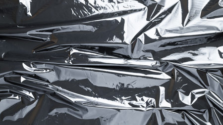 Cellophane wrap. Black shiny film bag pattern. Transparent dark cellophane texture for packaging,...