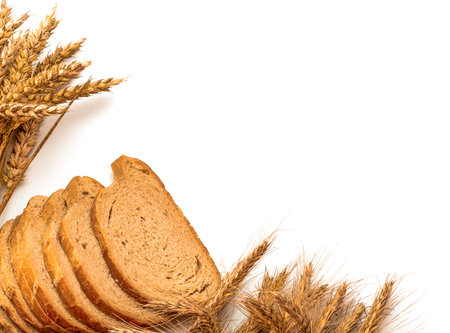 Delicious bread. Fresh loaf of rustic traditional bread with wheat grain ear or spike plant isolated...