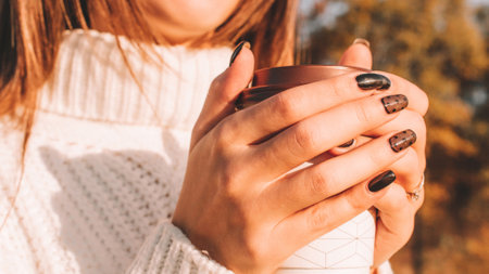 Girl drink coffee. Happy young woman with cup of tea in morning sitting outdoors sunlight. Beautiful female lifestyle.の写真素材