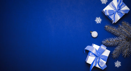 Happy Christmas. White gift with cyan bow, blue balls and winter tree in xmas decoration on azure...