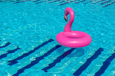 Summer sale. Pink inflatable flamingo in pool water for summer beach background. Minimal summer conceptの写真素材