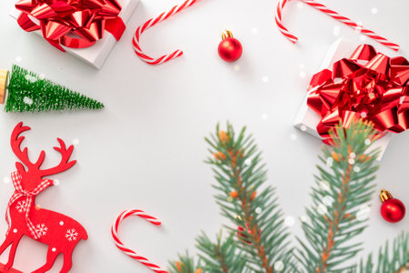 Gift boxes scarlet. White gifts with red ribbon, New Year balls and sparkling lights in Christmas composition on white background for greeting card. Xmas backdrop with space for textの写真素材