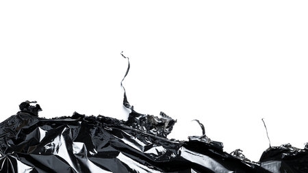 Plastic texture background. Wrap transparent dark cellophane isolated on white. Cellophane black shiny film bag pattern. Creative crumpled backgroundの写真素材