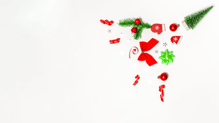 Xmas background white. Stocking, gifts, winter tree, ribbon and bow in Christmas composition on white background for greeting card. Flat lay, top view, copy spaceの写真素材