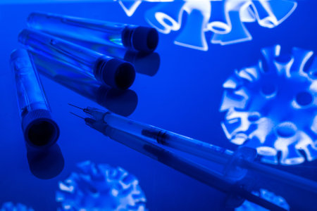 Virus protection. Medical syringe with needle for protection flu virus and coronavirus. Covid vaccine isolated on blue. Syringe, medical injectionの写真素材