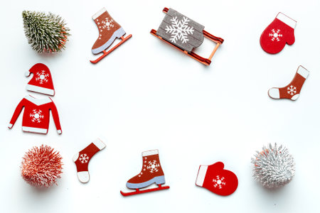 Holiday winter white. Stocking, gifts, winter tree, ribbon and bow in shape frame on white background for greeting card. Flat lay, top view, copy spaceの写真素材