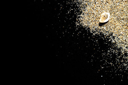 Desert pile sand isolated on black. Dust heap beach texture on shore background. Summer vacation and product advertisement conceptの写真素材