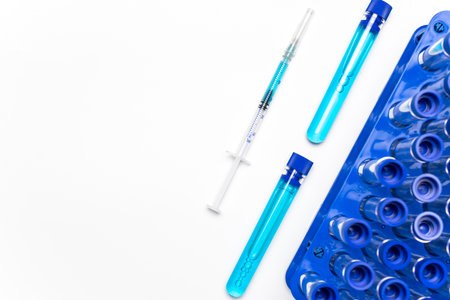Vaccine bottle. Medical syringe with needle for protection flu virus and coronavirus. Covid inoculation on white. Medicine plastic vaccination equipment with needleの写真素材