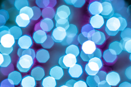 Blue light blur. Abstract Festive glitter Bokeh background. Soft yellow christmas backdrop