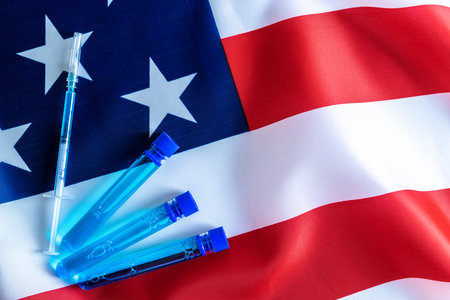 Cancer virus. Medical syringe with needle for protection flu virus and coronavirus. Covid vaccine usa flag of america. Medicine concept vaccination hypodermic injection treatmentの写真素材