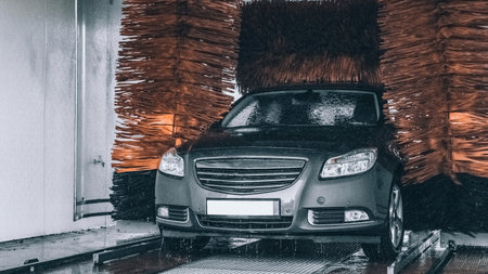 Foam water clean auto car on carwash hand service. Vehicle wash soap, foam on cleaner stationの写真素材
