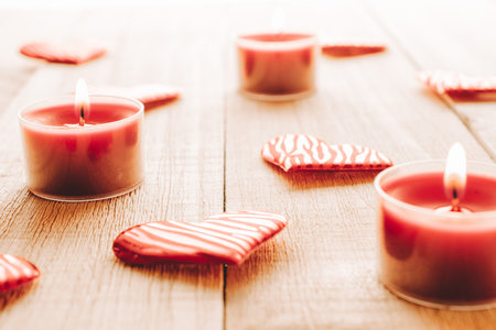 Valentines day minimal: red love hearts candle on wooden background. Sainte Valentine, mothers day, birthday greeting cards, invitation, celebration conceptの写真素材