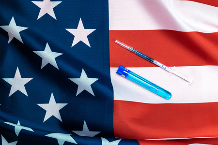 Vaccine bottle. Medical syringe with needle for protection flu virus and usa flag of america. Medicine plastic vaccination equipment with needleの写真素材