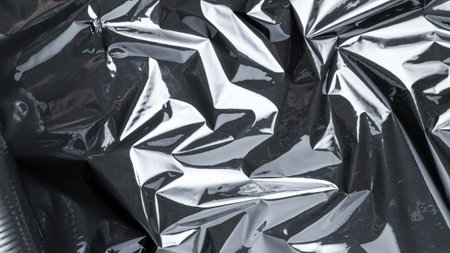 Cellophane wrap. Black shiny film bag pattern. Transparent dark cellophane texture for packaging,...