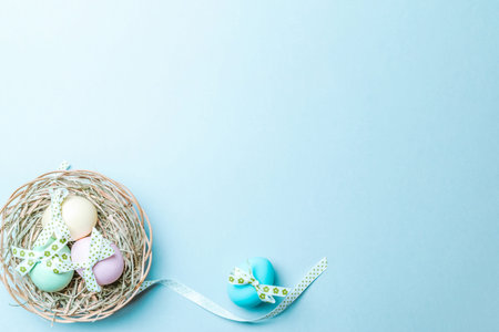 Easter border. Colorful egg with tape ribbon, spring tulips, feathers on pastel blue background in...