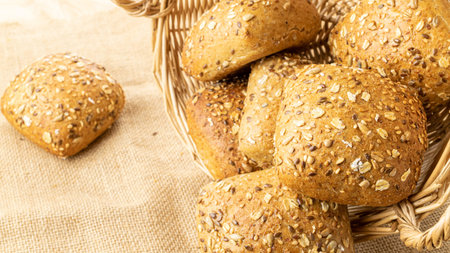 Cut bread. Fresh loaf of rustic traditional bread with wheat grain ear or spike plant on linen...