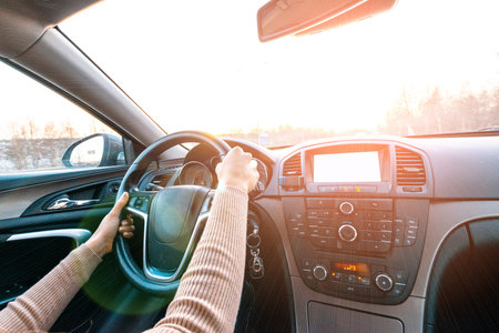 Car driving. Fun driver ride vehicle on road in travel trip. Happy young woman inside car on sunset...