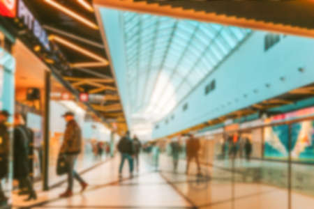 Shopping center blurred background. People shopping in modern commercial mall center. Interior of retail center store in soft focus. Image for background useの写真素材