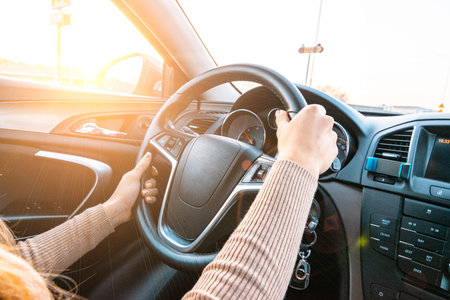 Ride car. Young happy woman have travel trip on road. Fun driver in winter vacation ride concept....