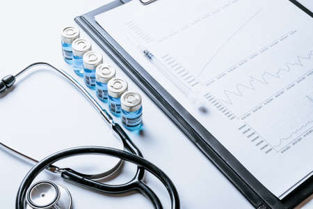 Statistics covid. Doctor stethoscope, hospital healthcare infographic charts and analytic medical statistics on hospital background. Global economy recovery after Covid 19 conceptの写真素材